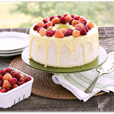 Angel food cake, white with yellow drizzle and strawberries