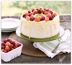 Angel food cake, white with yellow drizzle and strawberries