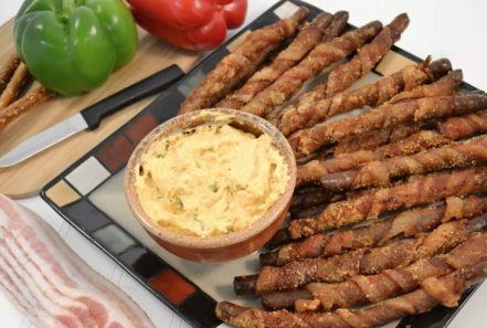 Bacon wrapped pretzel rods with cheese dip and Rada Cutlery